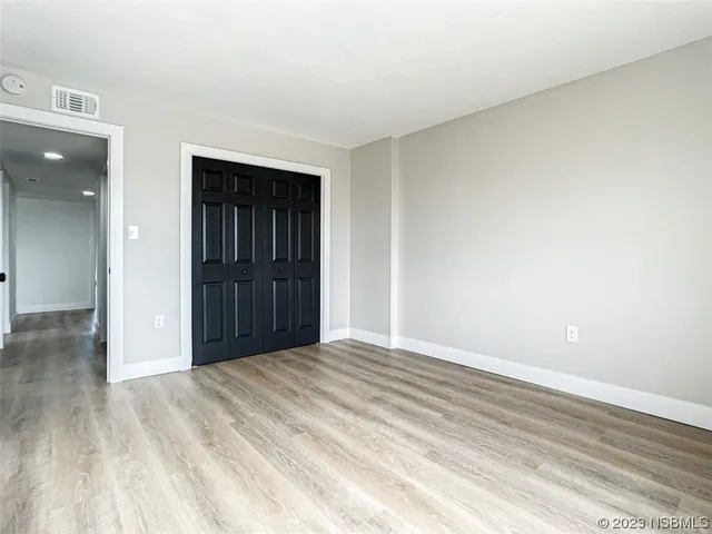 a view of an empty room and wooden floor