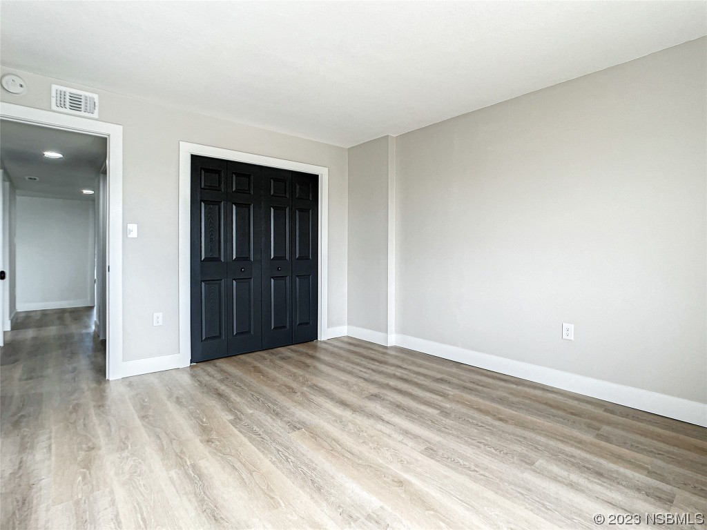 4435 South Atlantic Avenue, Unit 311 Ponce Inlet, FL 32127 - Photo 17 of 44 a view of an empty room and wooden floor