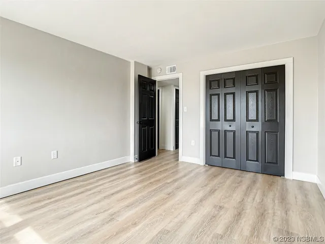 a view of an empty room with closet area