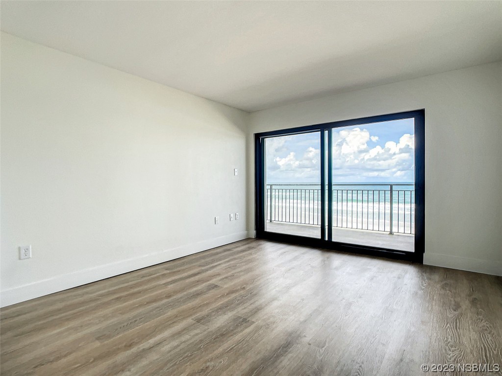 4435 South Atlantic Avenue, Unit 311 Ponce Inlet, FL 32127 - Photo 28 of 44 a view of a room with wooden floor and windows