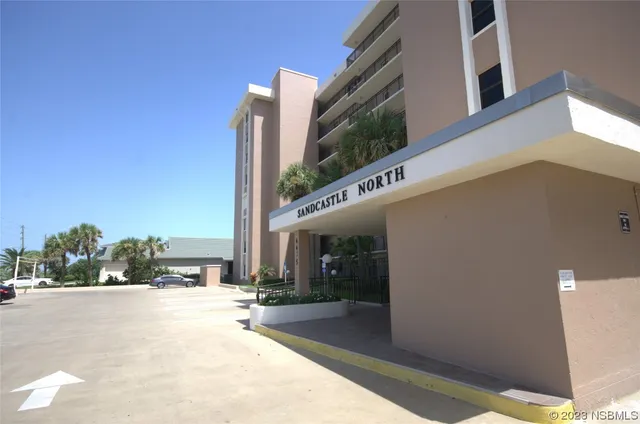 a view of a dining room with furniture wooden floor and a chandelier