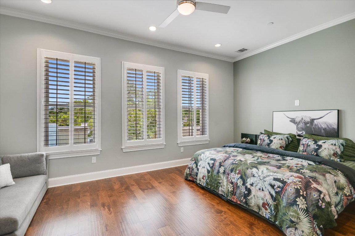 1023 Juniper Street Austin, TX 78702 - Photo 12 of 31 a bedroom with a large bed and a couch