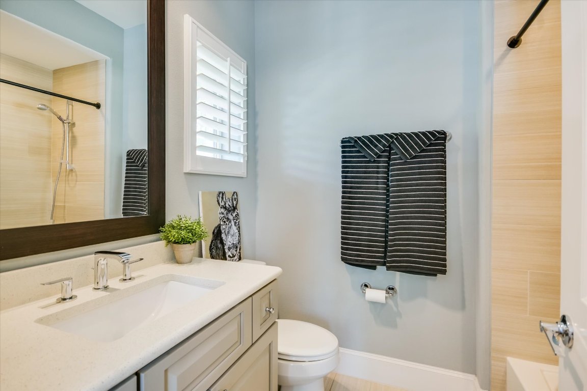 1023 Juniper Street Austin, TX 78702 - Photo 18 of 31 a bathroom with a sink a toilet and shower