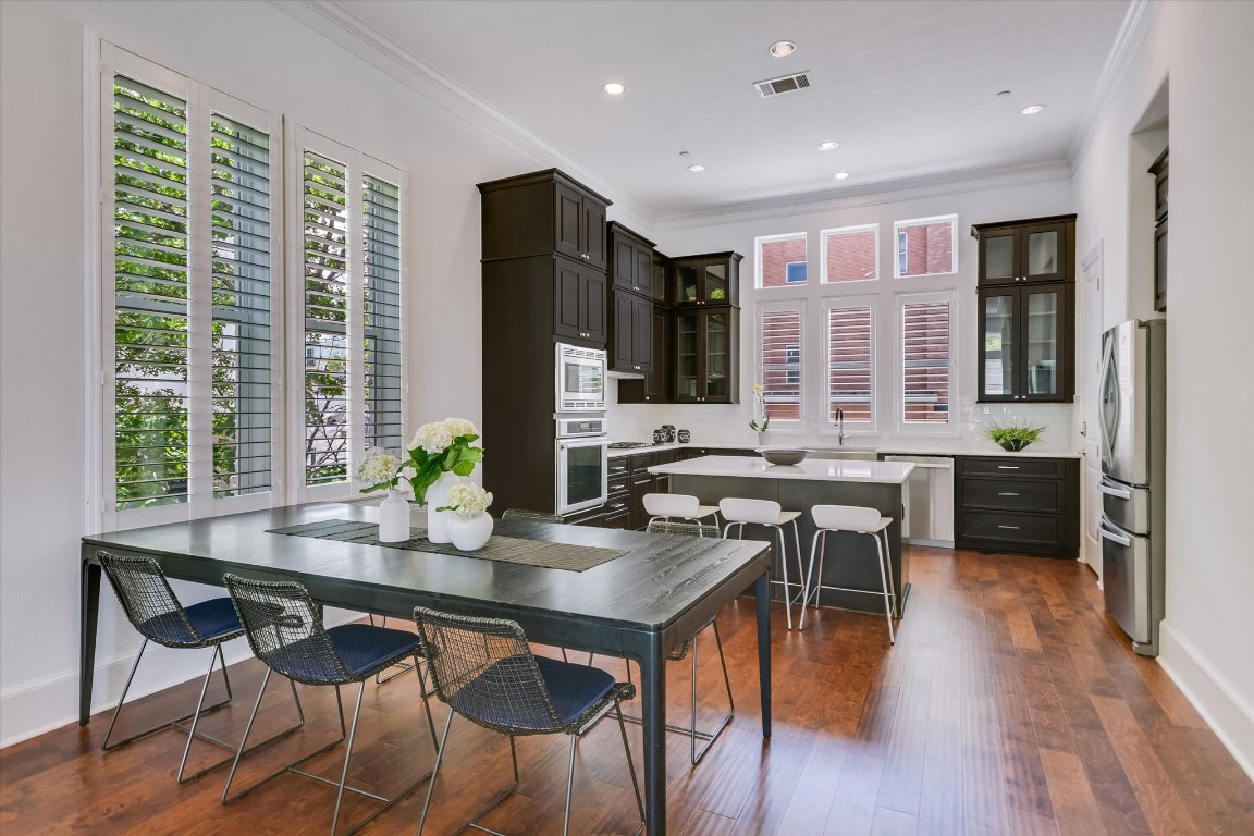 1023 Juniper Street Austin, TX 78702 - Photo 2 of 31 a room with a table chairs and flat screen tv