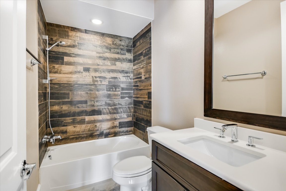 1023 Juniper Street Austin, TX 78702 - Photo 26 of 31 a bathroom with a bathtub shower sink vanity and toilet