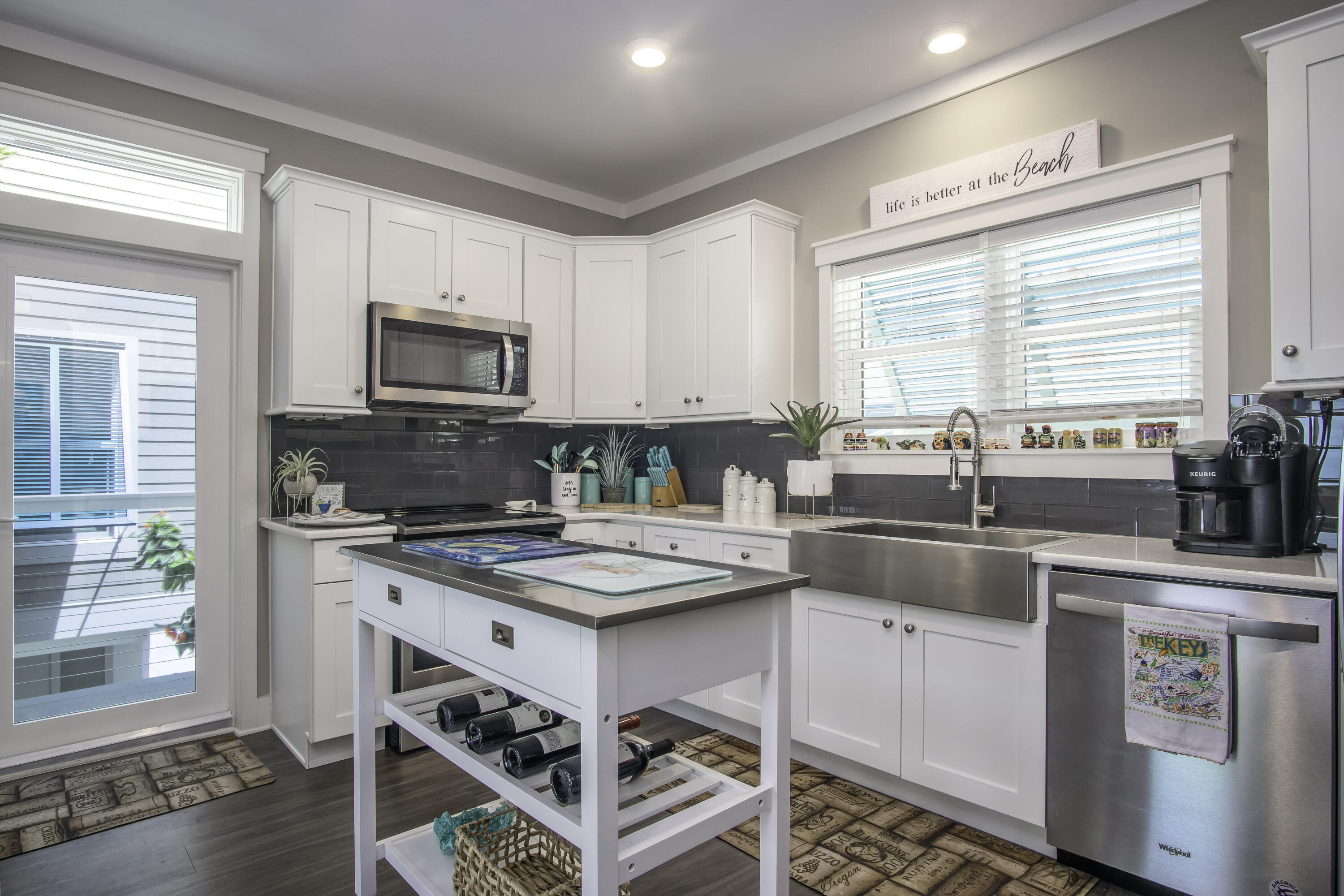101 11th Street, Unit 11 Marathon, FL 33050 - Photo 11 of 67 a kitchen with a stove a sink a microwave a dining table and chairs