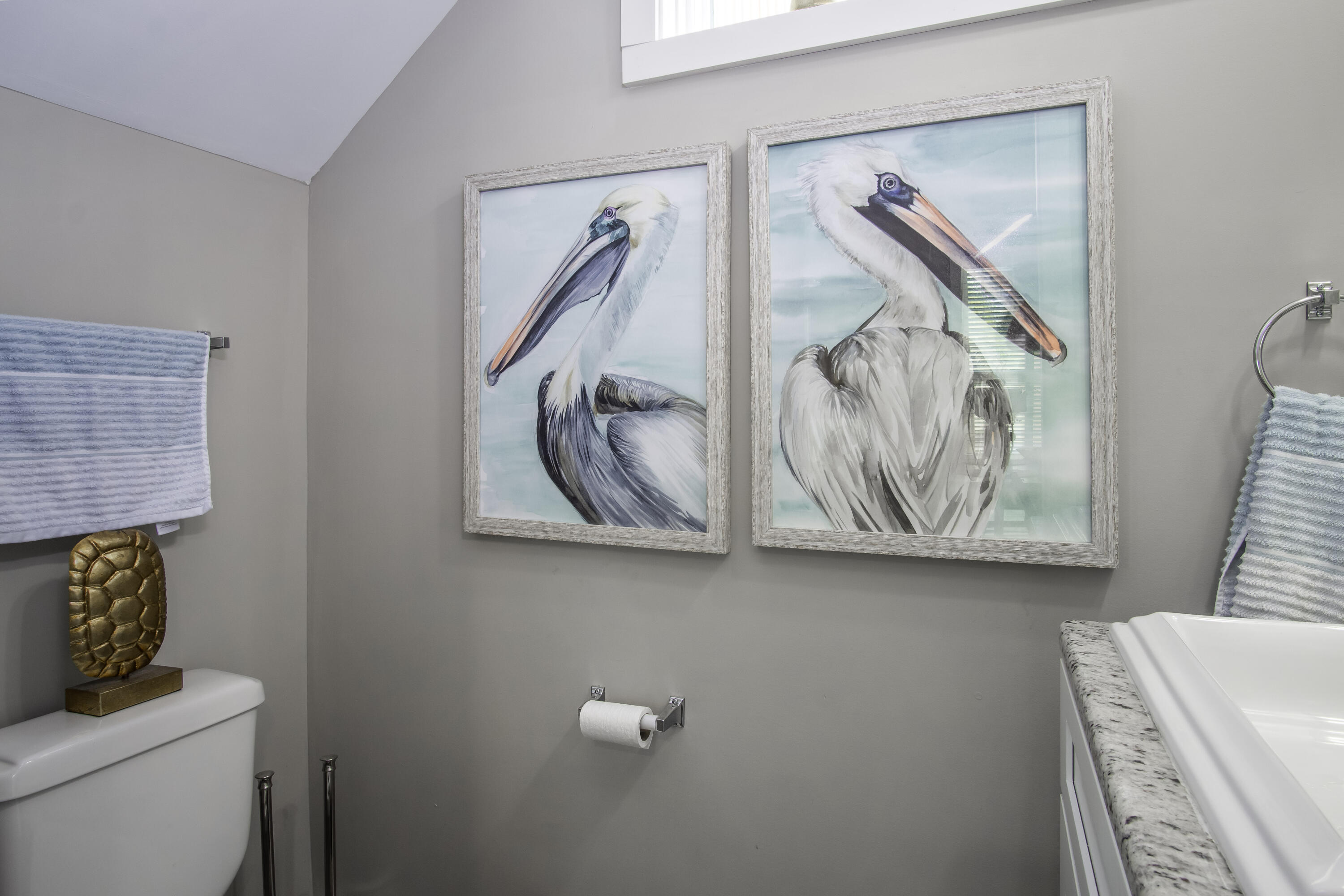 101 11th Street, Unit 11 Marathon, FL 33050 - Photo 27 of 67 a bathroom with a painting on the wall and a toilet