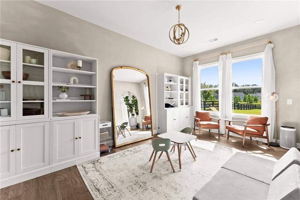 3675 Andover Street Cumming, GA 30028 - Photo 12 of 52 a living room with furniture a dining table and a large window