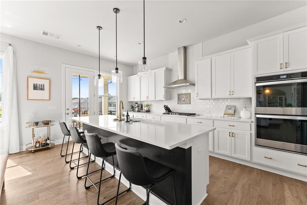 3675 Andover Street Cumming, GA 30028 - Photo 14 of 52 a kitchen with white cabinets and white appliances