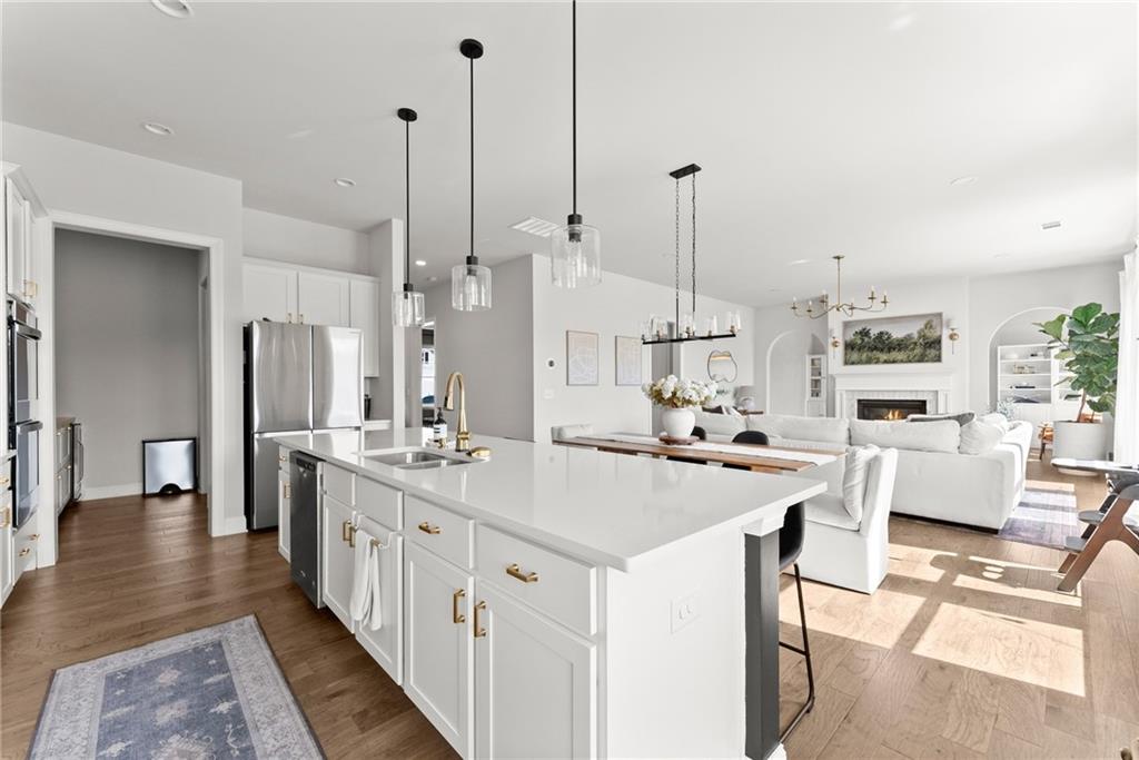 3675 Andover Street Cumming, GA 30028 - Photo 19 of 52 a kitchen with stainless steel appliances kitchen island a large island a sink a stove and a refrigerator