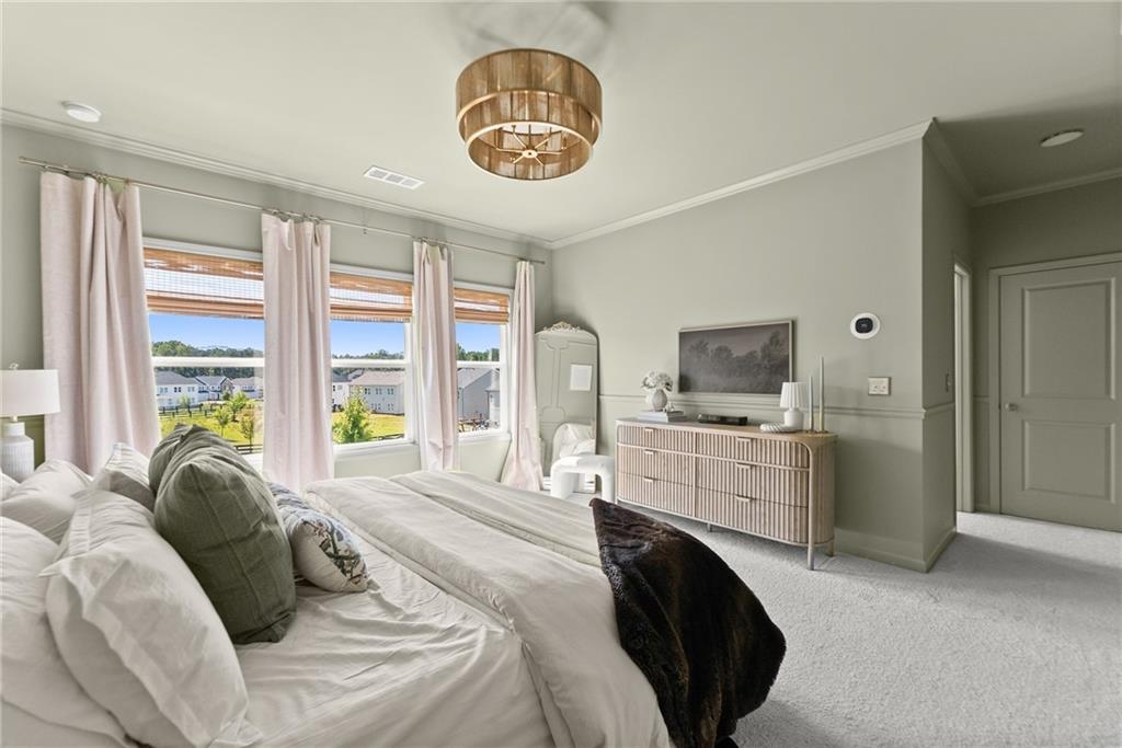 3675 Andover Street Cumming, GA 30028 - Photo 27 of 52 a bedroom with a bed a window and a chandelier