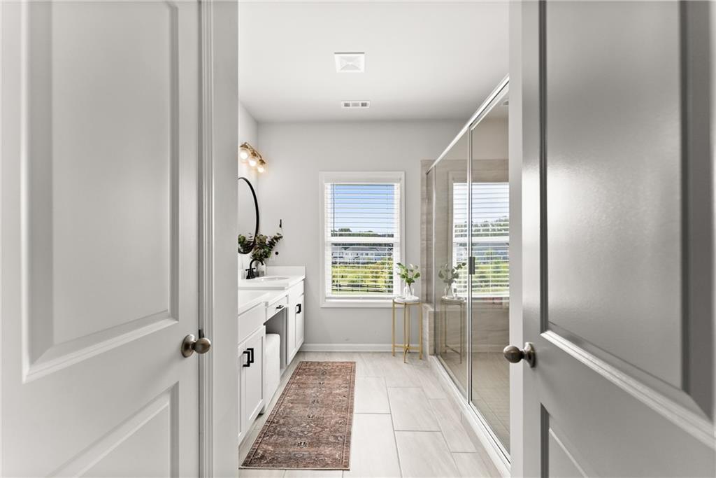3675 Andover Street Cumming, GA 30028 - Photo 28 of 52 a bathroom with a tub shower and window