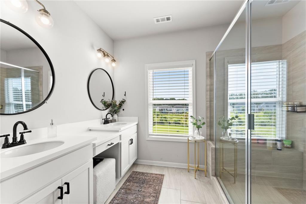 3675 Andover Street Cumming, GA 30028 - Photo 29 of 52 a bathroom with 2 sink and a mirror