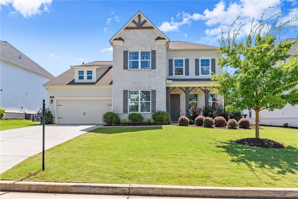 3675 Andover Street Cumming, GA 30028 - Photo 3 of 52 a front view of a house with a yard