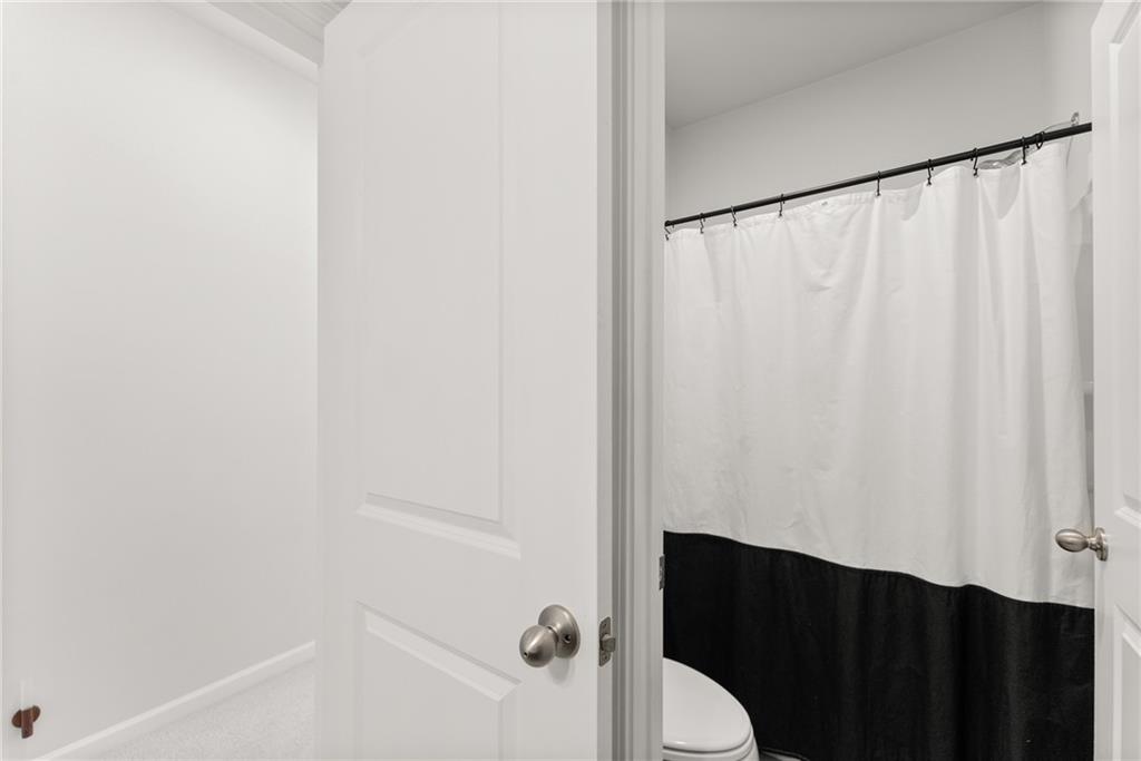 3675 Andover Street Cumming, GA 30028 - Photo 32 of 52 a bathroom with a shower curtain