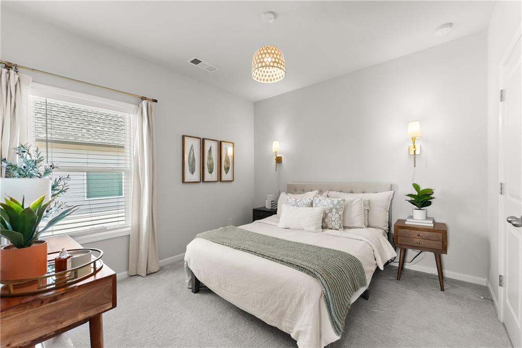 3675 Andover Street Cumming, GA 30028 - Photo 33 of 52 a bedroom with a bed and a potted plant