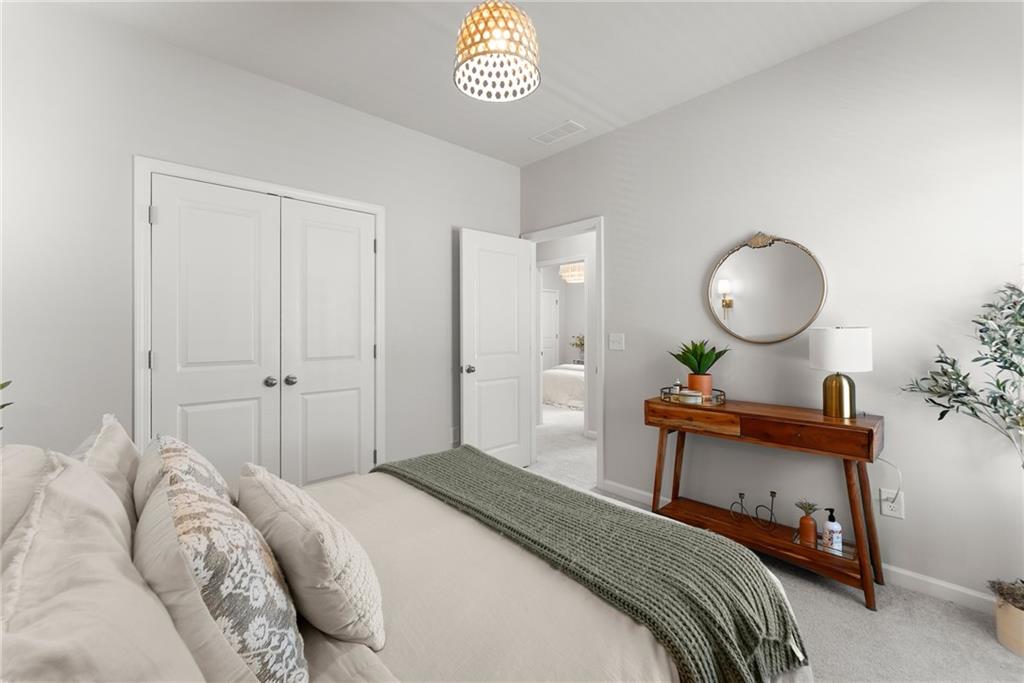 3675 Andover Street Cumming, GA 30028 - Photo 35 of 52 a bedroom with a bed and a chandelier