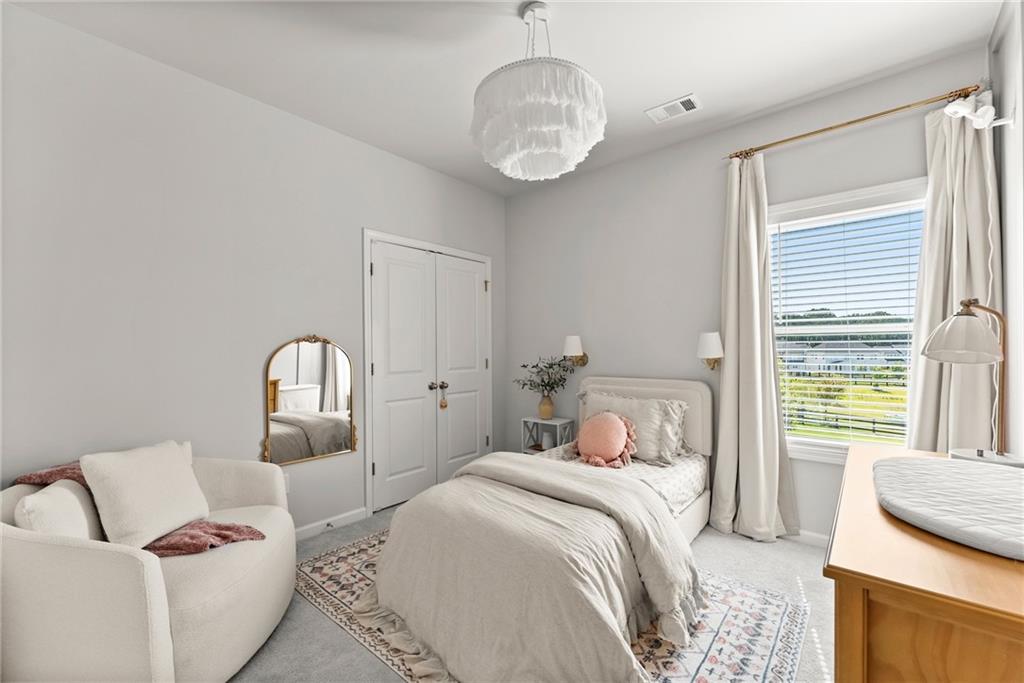 3675 Andover Street Cumming, GA 30028 - Photo 38 of 52 a bedroom with bed and wooden floor