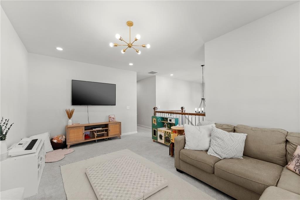 3675 Andover Street Cumming, GA 30028 - Photo 42 of 52 a living room with furniture and a flat screen tv