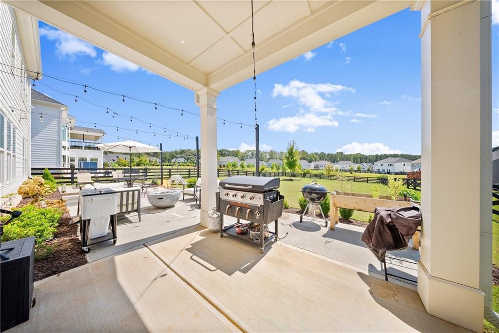 3675 Andover Street Cumming, GA 30028 - Photo 43 of 52 a view of a patio with couches potted plants and a table