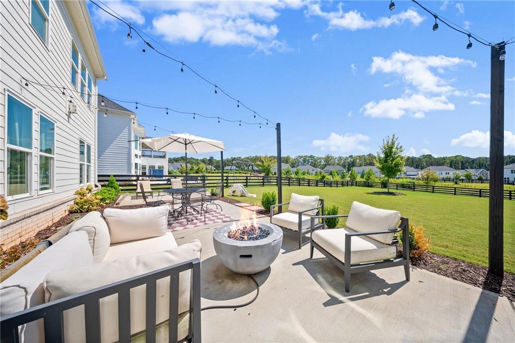 3675 Andover Street Cumming, GA 30028 - Photo 44 of 52 a view of a patio with couches potted plants and a big lake view