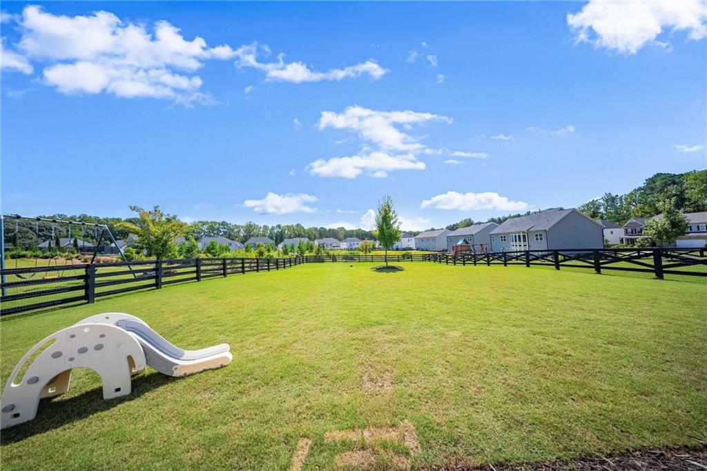 3675 Andover Street Cumming, GA 30028 - Photo 46 of 52 a view of a swimming pool with lawn chairs and a big yard