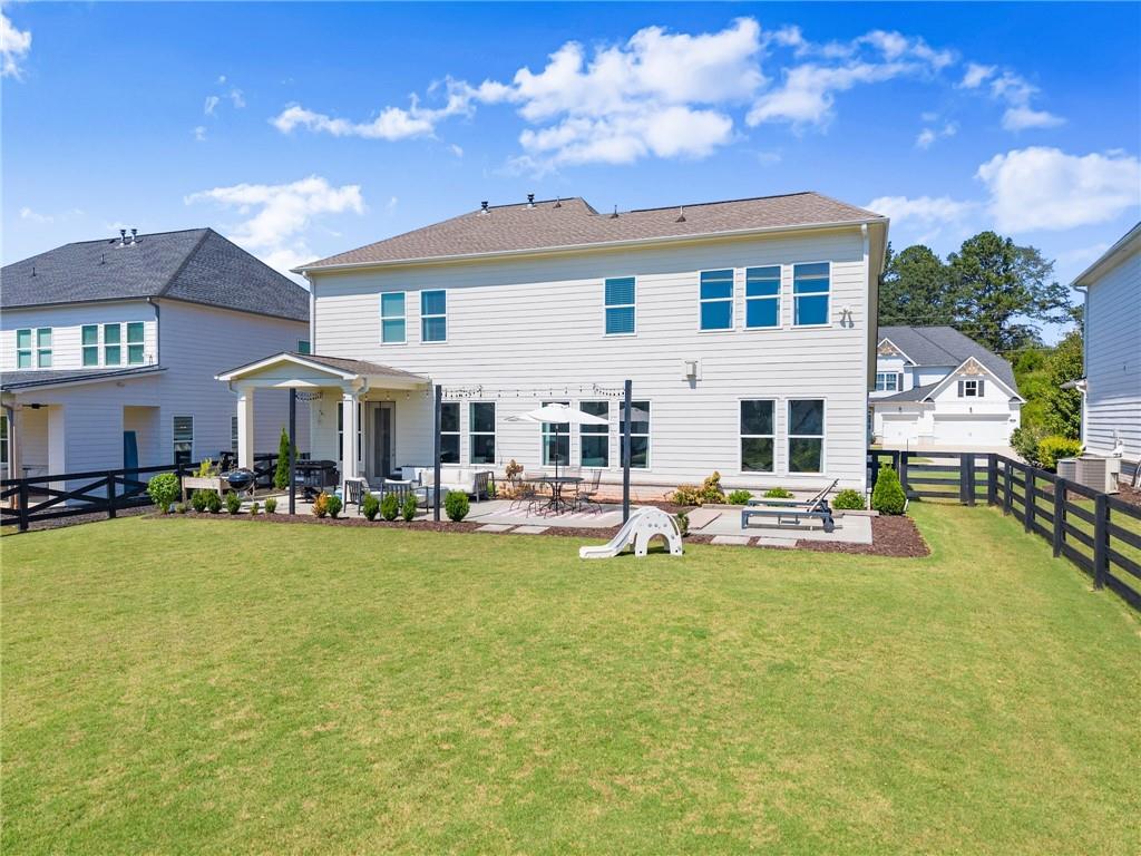 3675 Andover Street Cumming, GA 30028 - Photo 47 of 52 a view of a house with patio swimming pool and a yard