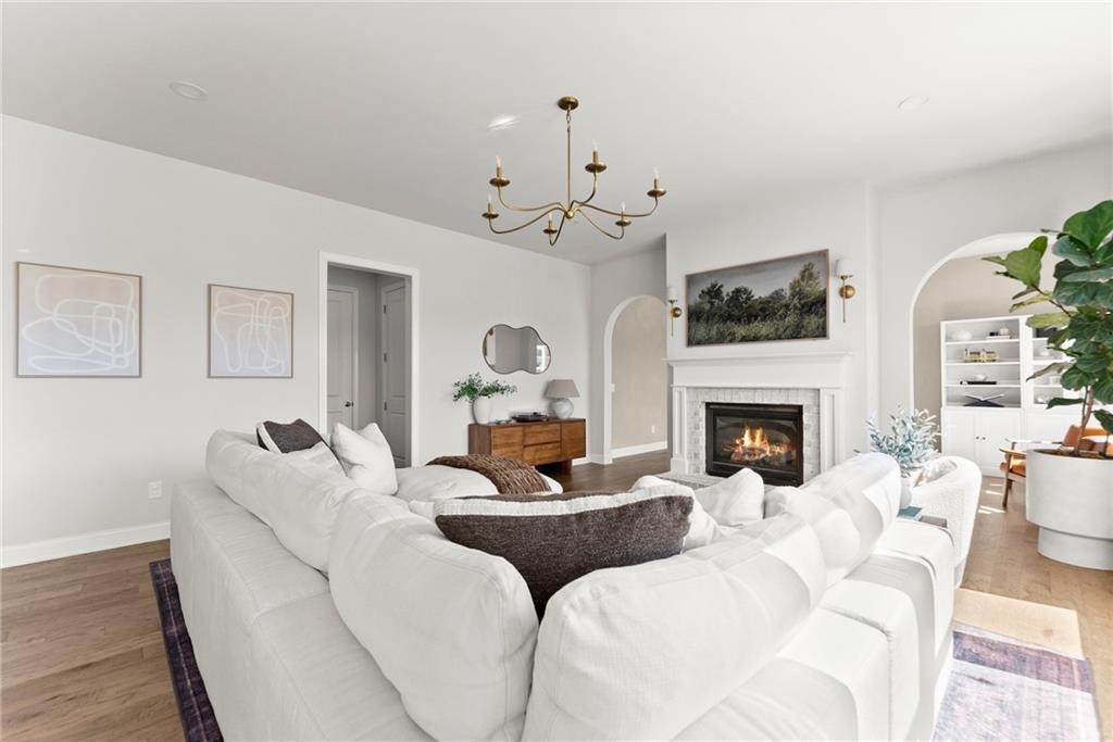 3675 Andover Street Cumming, GA 30028 - Photo 8 of 52 a living room with furniture a fireplace and a flat screen tv