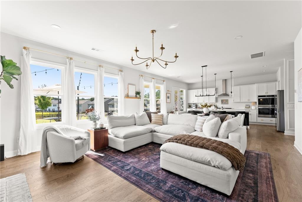 3675 Andover Street Cumming, GA 30028 - Photo 9 of 52 a living room with furniture kitchen view and a chandelier