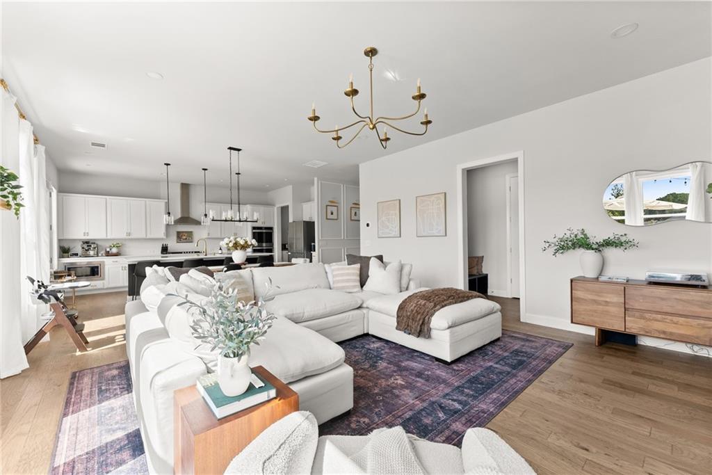 3675 Andover Street Cumming, GA 30028 - Photo 10 of 52 a living room with furniture or kitchen view and a wooden floor