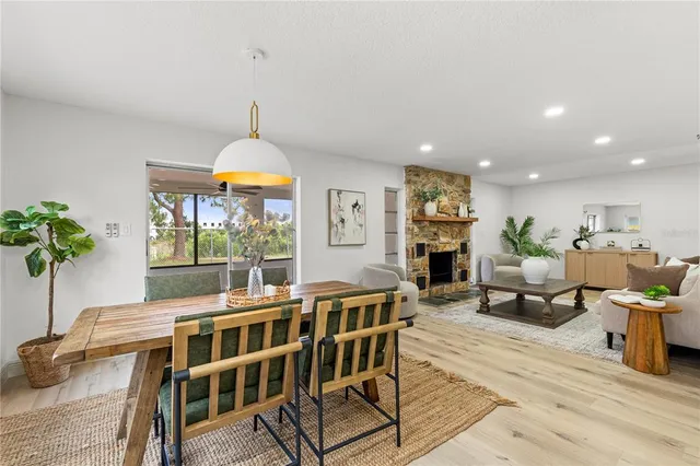 a living room with fireplace furniture and a potted plant