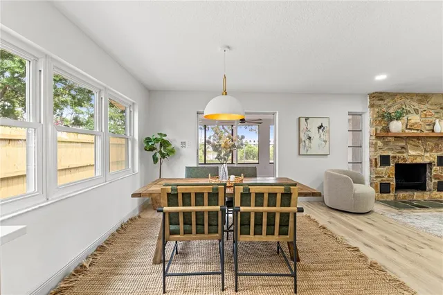 a dining room with furniture window and wooden floor