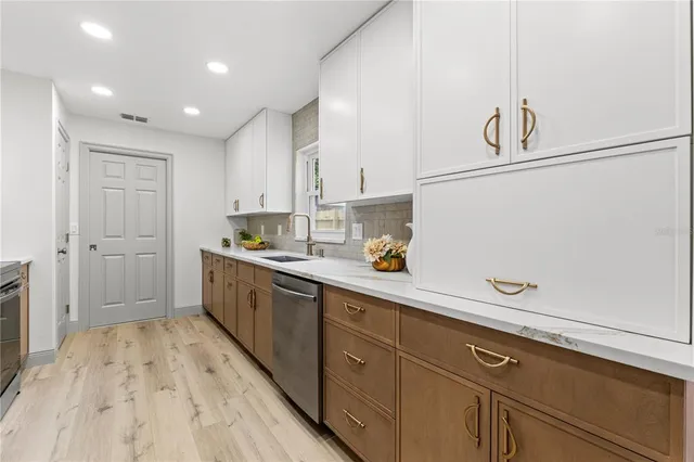 a kitchen with a sink and cabinets