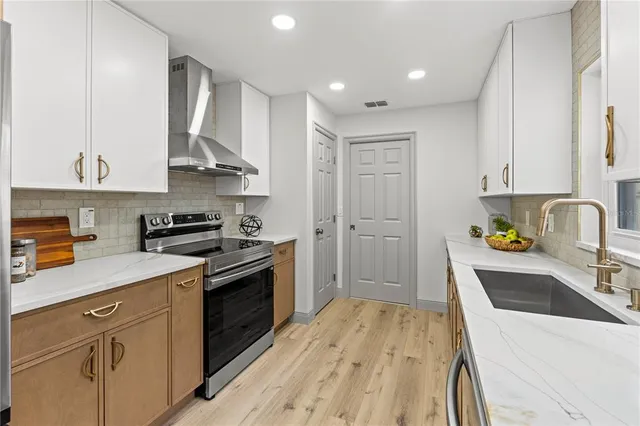 a kitchen with a sink a stove and cabinets