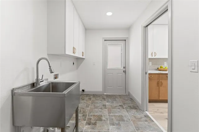 a kitchen with sink and refrigerator