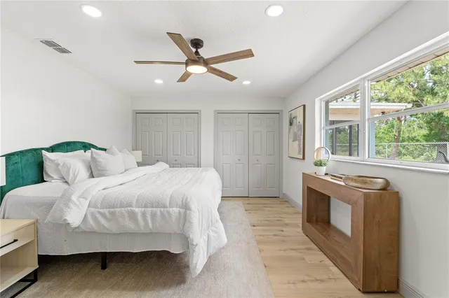 a spacious bedroom with a bed and a window