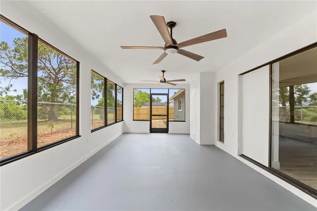 a view of a livingroom with a ceiling fan and window