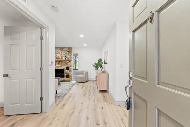 a view of a hallway and wooden floor cabinet and entryway