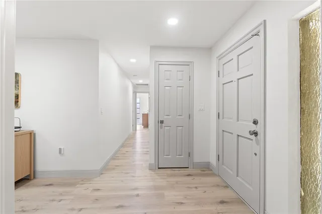 a view of a hallway with wooden floor