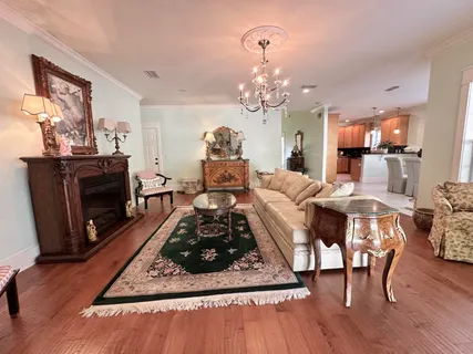 a bedroom with a bed large window and dresser