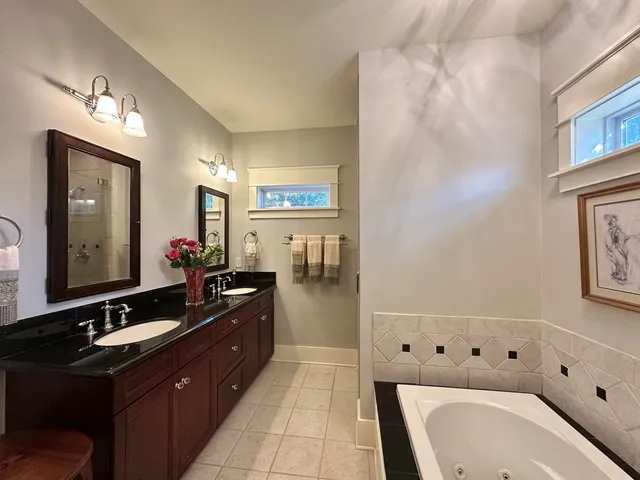 a view of washer and dryer with bathroom in the background