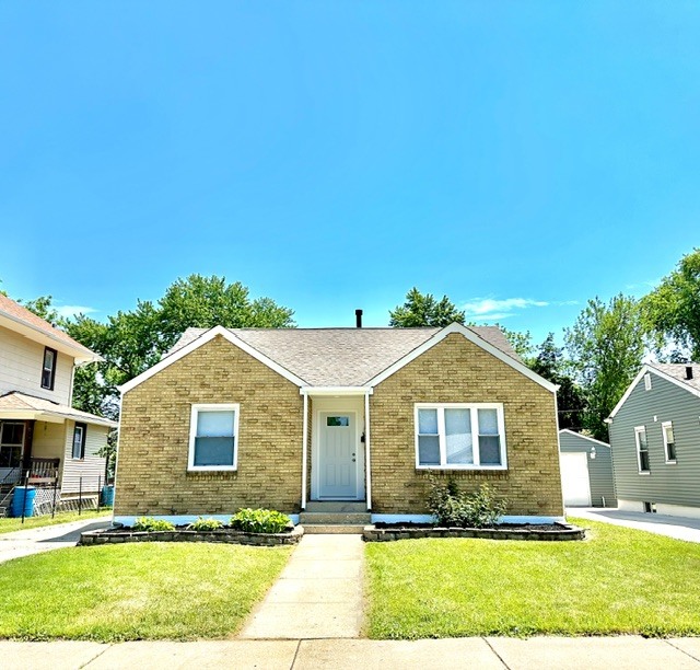 513 Cookane Avenue Elgin, IL 60120 - Photo 1 of 26 a front view of a house with a yard