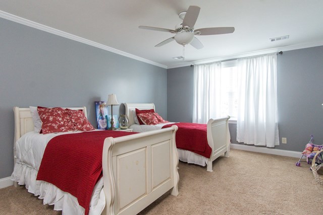 112 Pate Road Macon, GA 31210 - Photo 20 of 24 a bedroom with a bed and a chandelier