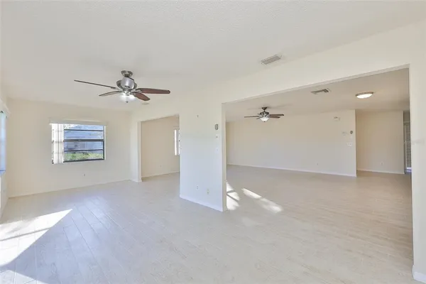 a view of a livingroom with a ceiling fan and window
