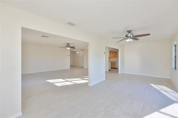 a view of a room with a ceiling fan and bathroom