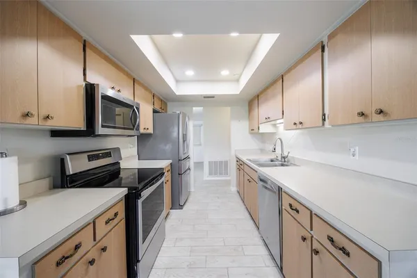 a kitchen with a sink a stove and cabinets