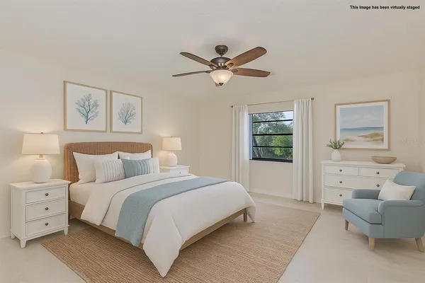 an empty room with ceiling fan and window