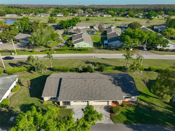 an aerial view of residential house with outdoor space and lake view
