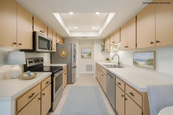 a kitchen with stainless steel appliances a stove sink microwave and cabinets
