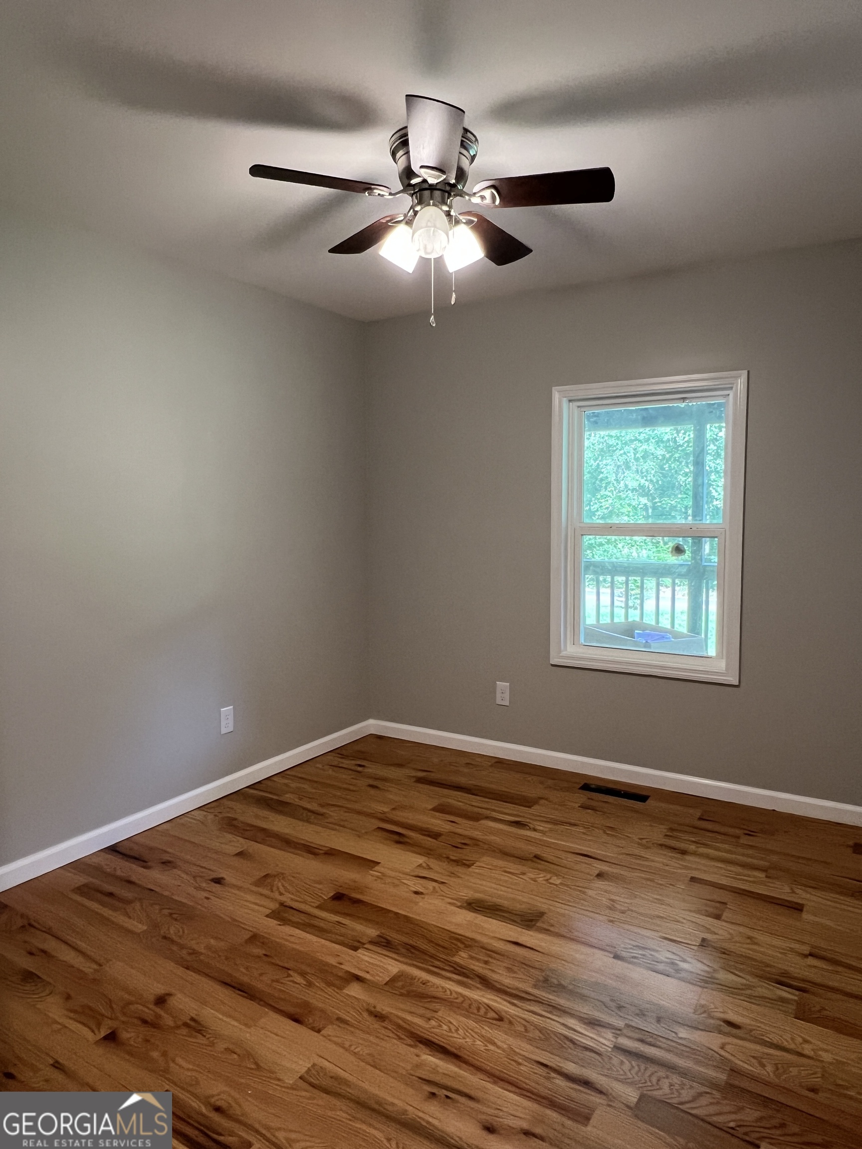 984 Plowshare Road Carrollton, GA 30117 - Photo 8 of 15 a view of an empty room with window and wooden floor
